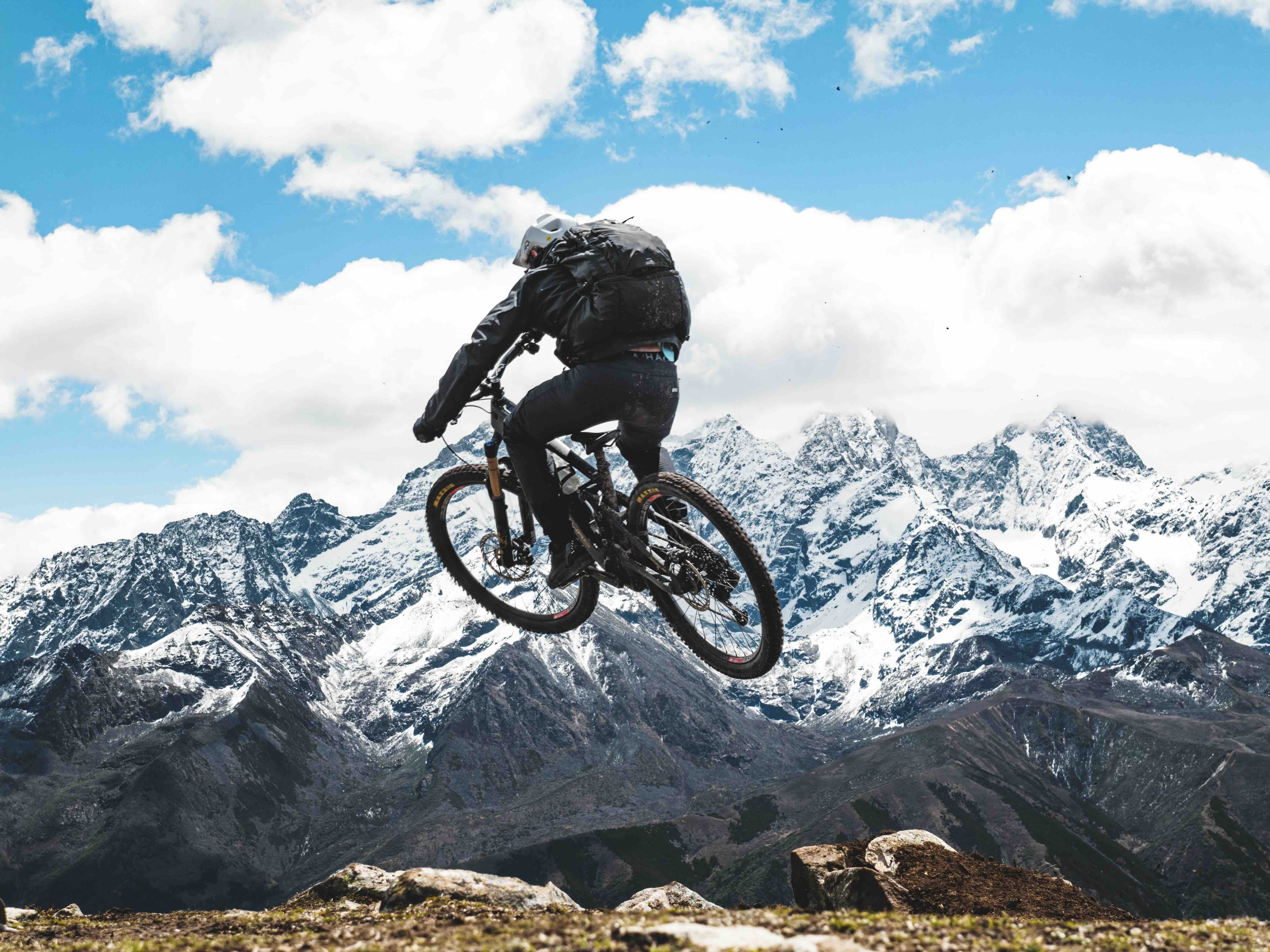Mountain biker on steep natural trail in Chinese alpine mountains