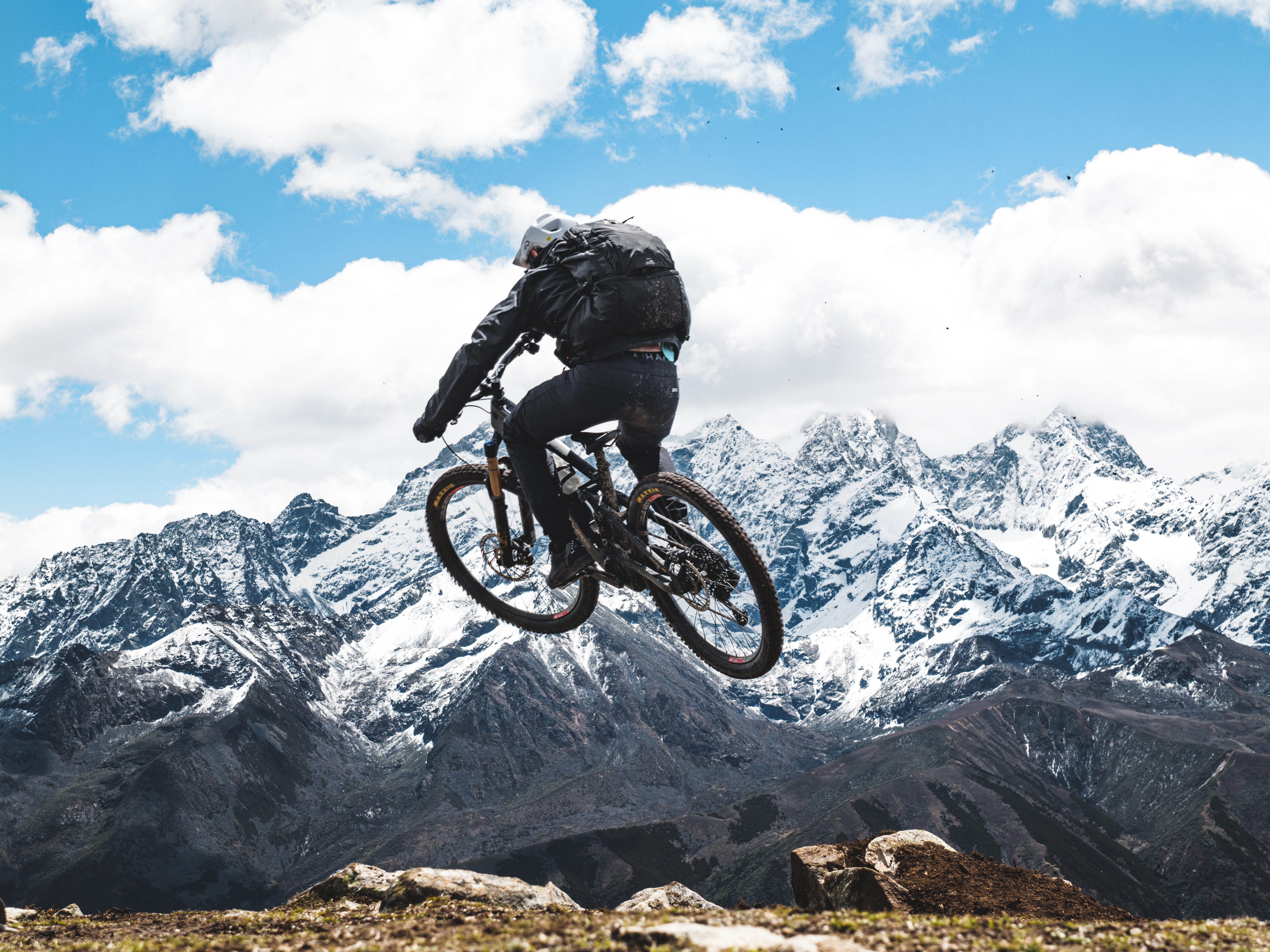 Mountain biker on steep natural trail in Chinese alpine mountains