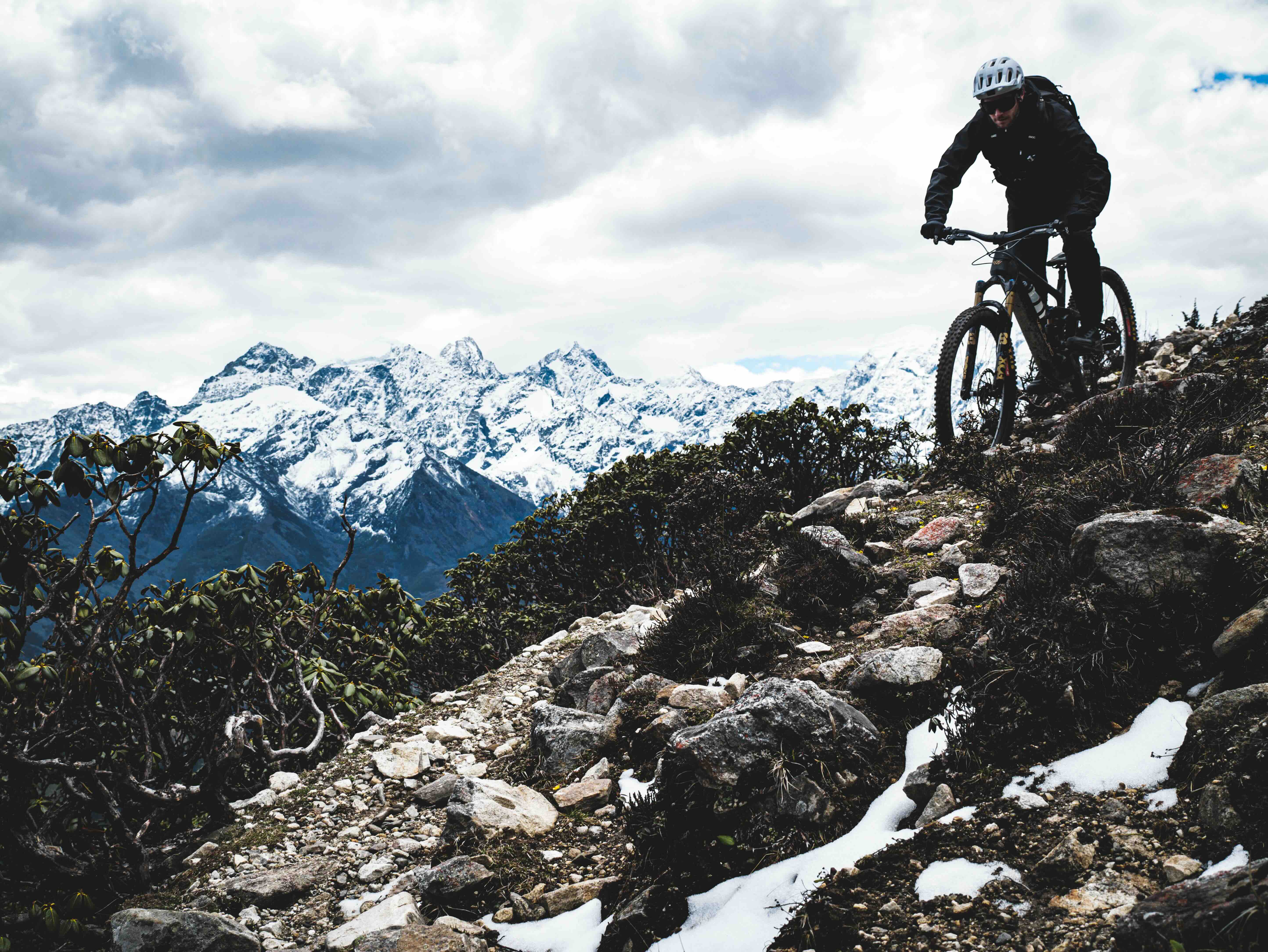 Aerial drone view of riders on high altitude mountain pass in Sichuan