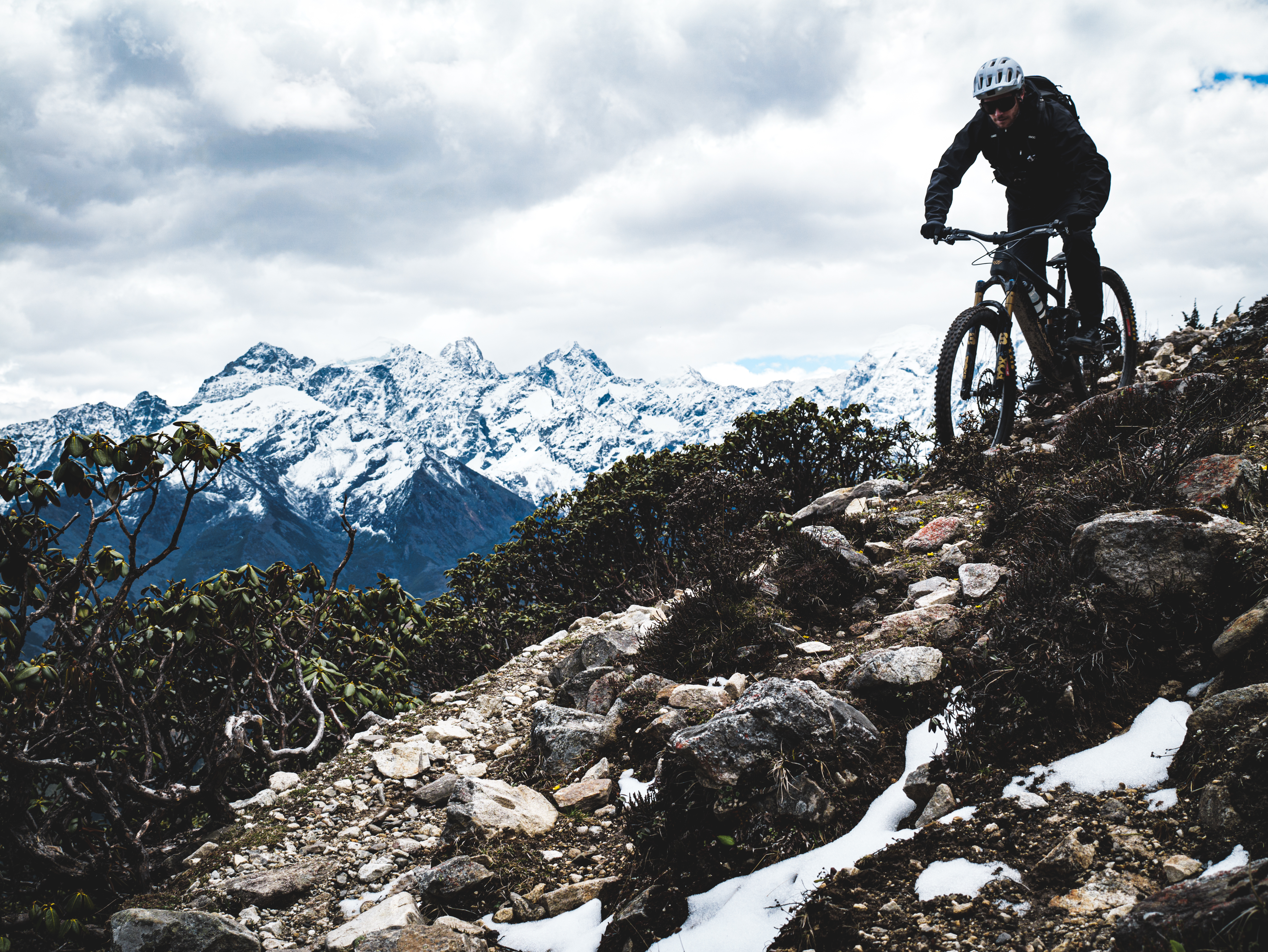 Aerial drone view of riders on high altitude mountain pass in Sichuan